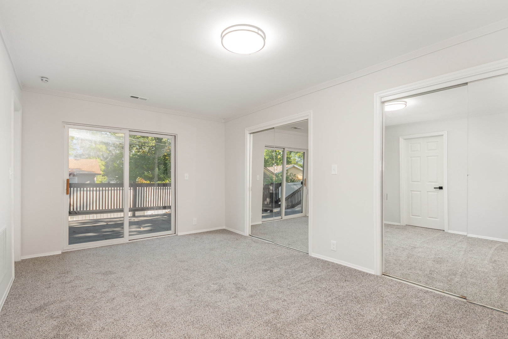 305 Luana Road Joliet, IL 60433 - Photo 9 of 16 an empty room with sliding door and wooden floor
