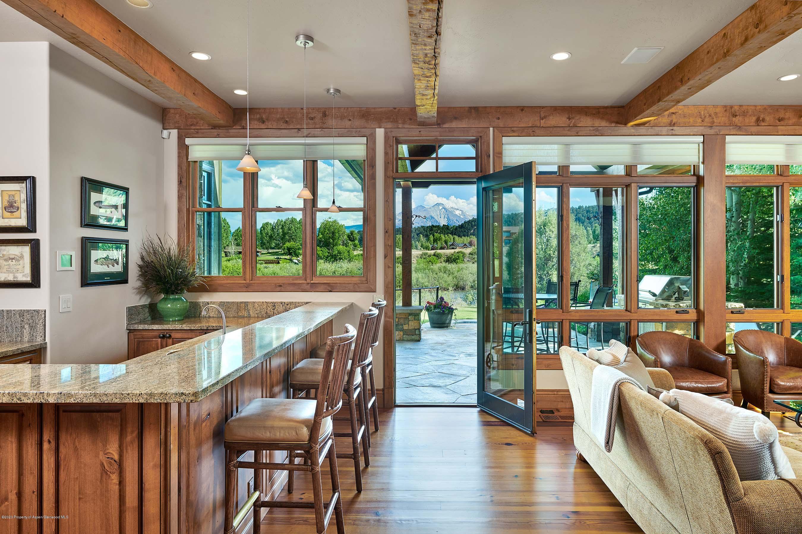 318 River's Bend Carbondale, CO 81623 - Photo 25 of 39 a dining room with furniture large windows and wooden floor