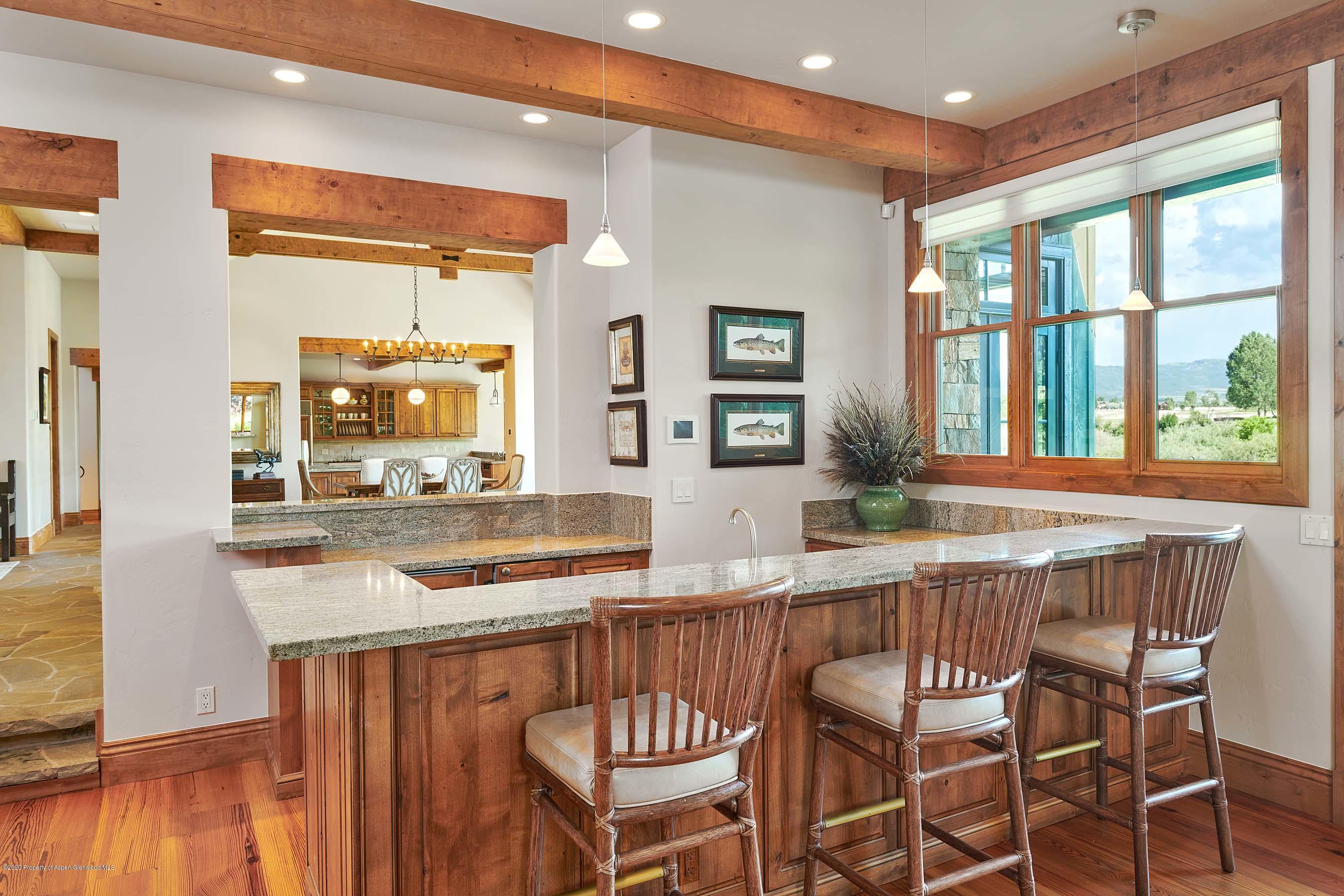 318 River's Bend Carbondale, CO 81623 - Photo 27 of 39 a kitchen with stainless steel appliances granite countertop a stove a sink and a dining table with granite countertops
