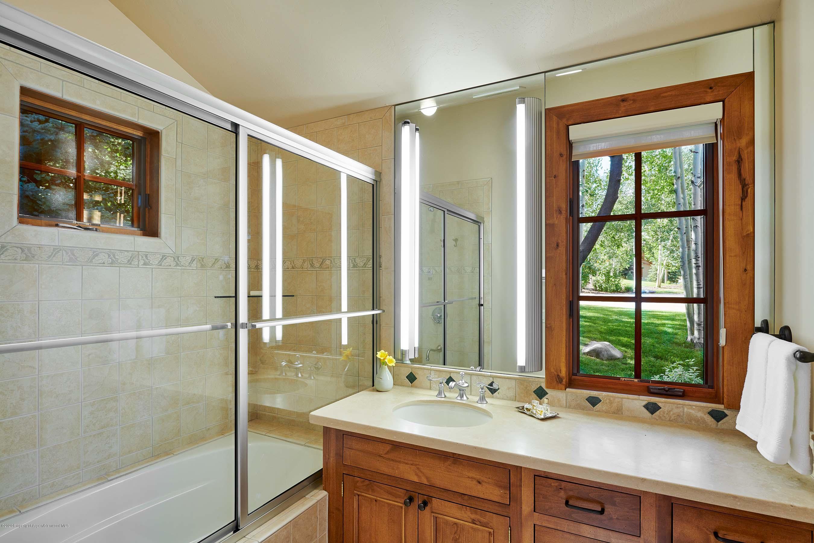 318 River's Bend Carbondale, CO 81623 - Photo 31 of 39 a bathroom with a granite countertop sink mirror and a bathtub