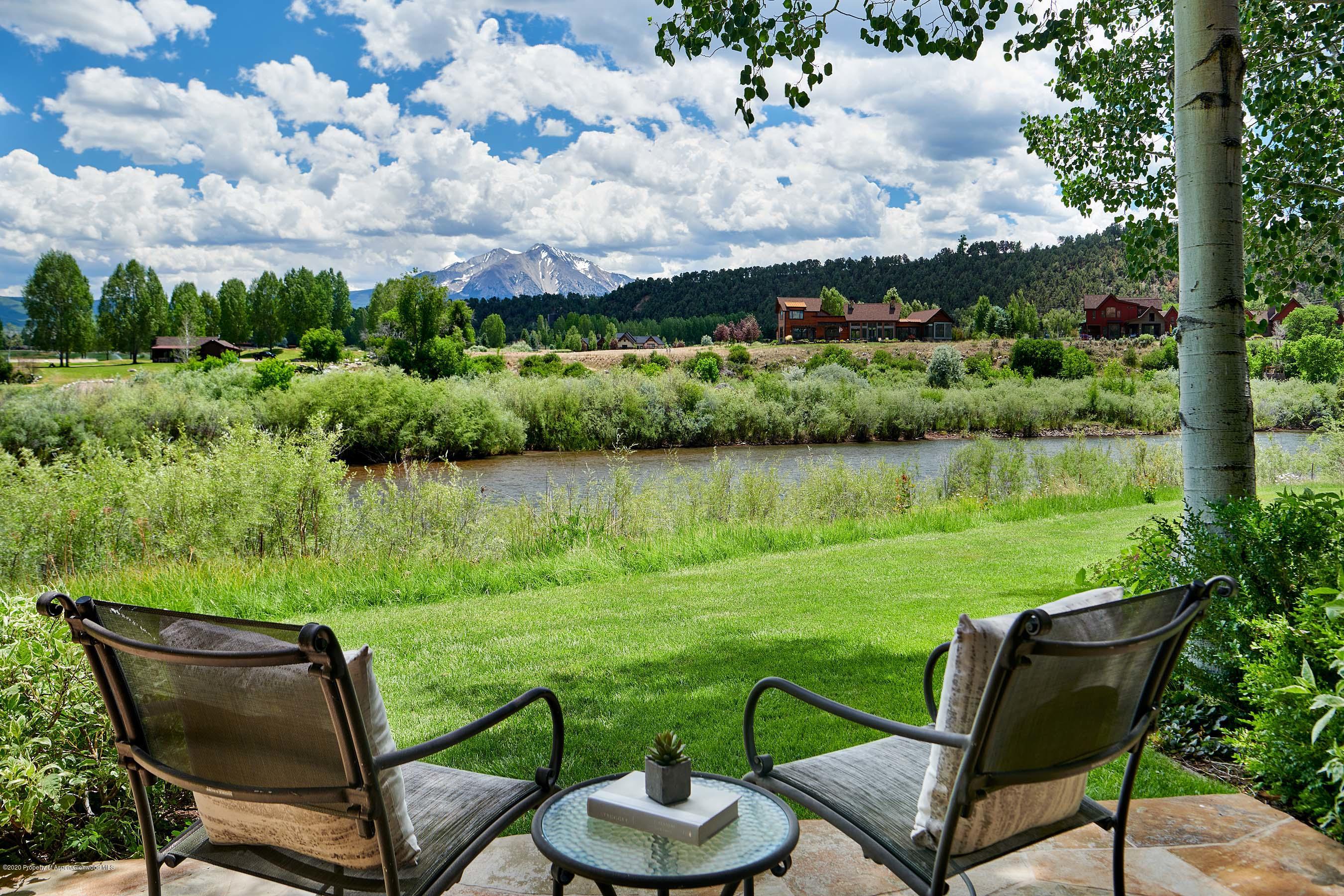 318 River's Bend Carbondale, CO 81623 - Photo 36 of 39 a view of a lake with furniture and a yard