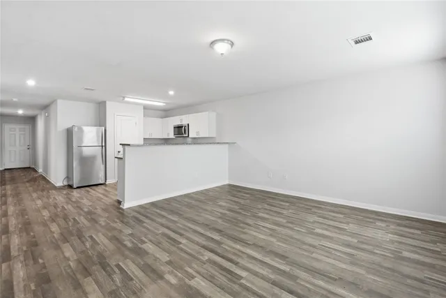 a view of a kitchen with a sink and a refrigerator