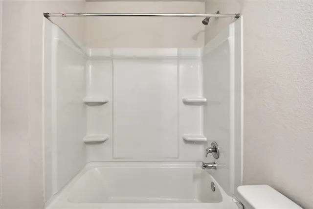 a bathroom with a shower and toilet