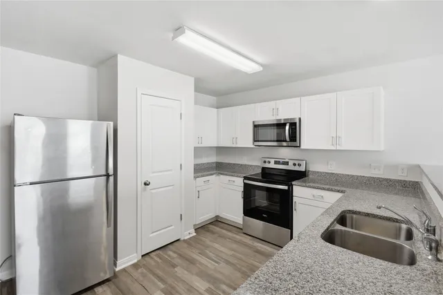 a kitchen with a refrigerator stove and sink