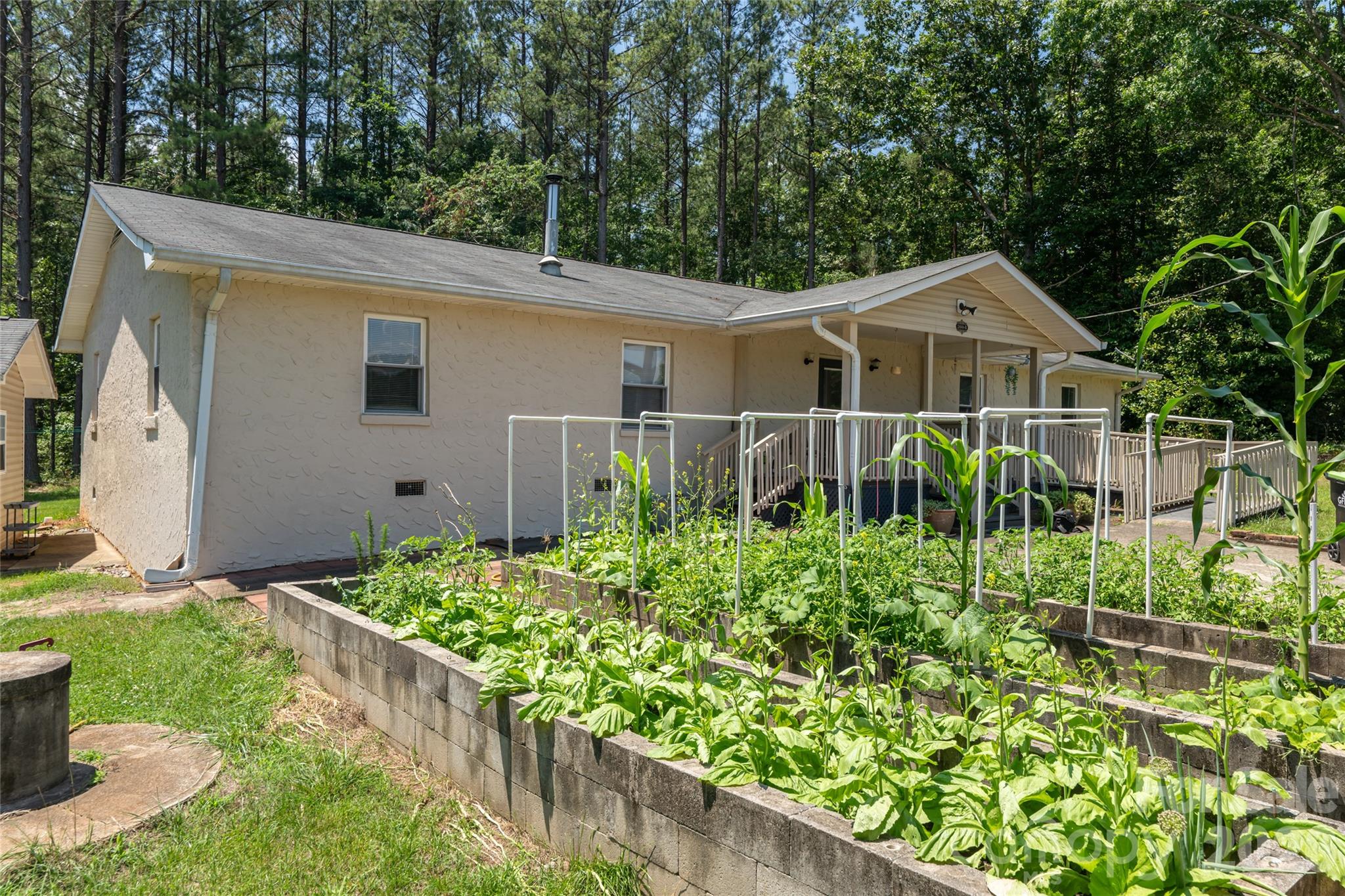 2800 Coxe Road Tryon, NC 28782 - Photo 25 of 40 a view of a small garden in front of a house with wooden fence