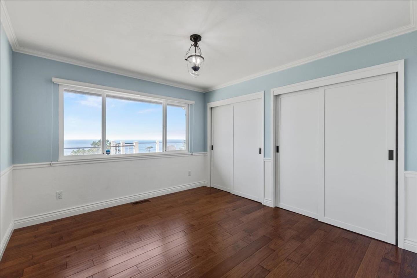 15 Mentone Road Carmel, CA 93923 - Photo 18 of 47 a view of an empty room with wooden floor and a window