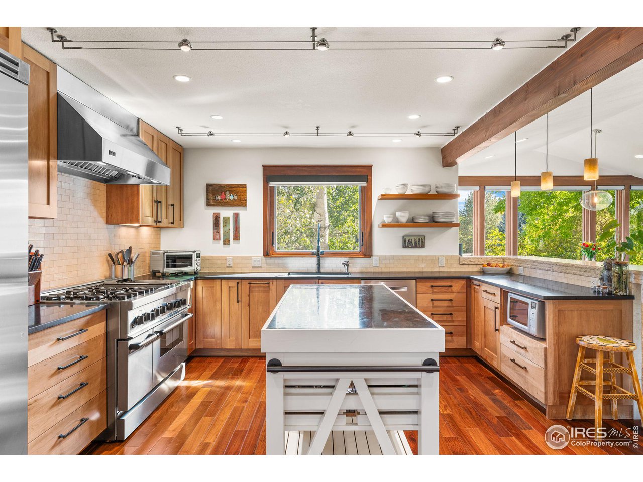 2545 Tamarack Avenue Boulder, CO 80304 - Photo 14 of 40 a kitchen with a stove a sink and a wooden cabinets