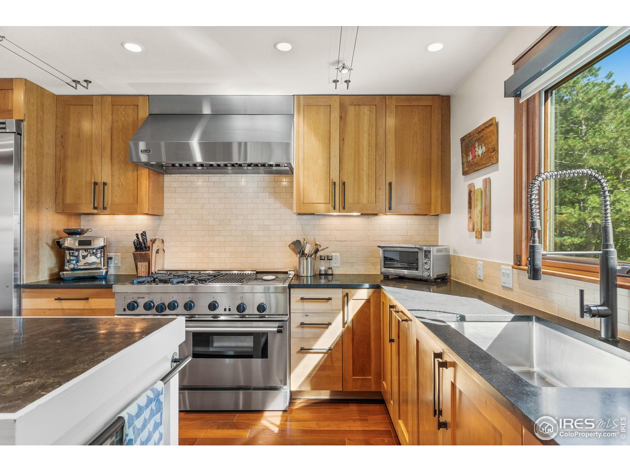 2545 Tamarack Avenue Boulder, CO 80304 - Photo 16 of 40 a kitchen with stainless steel appliances granite countertop a sink stove and refrigerator