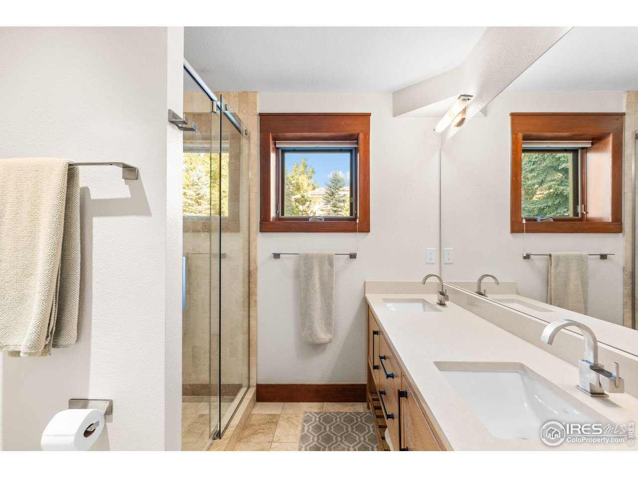 2545 Tamarack Avenue Boulder, CO 80304 - Photo 33 of 40 a bathroom with a sink a mirror and a shower