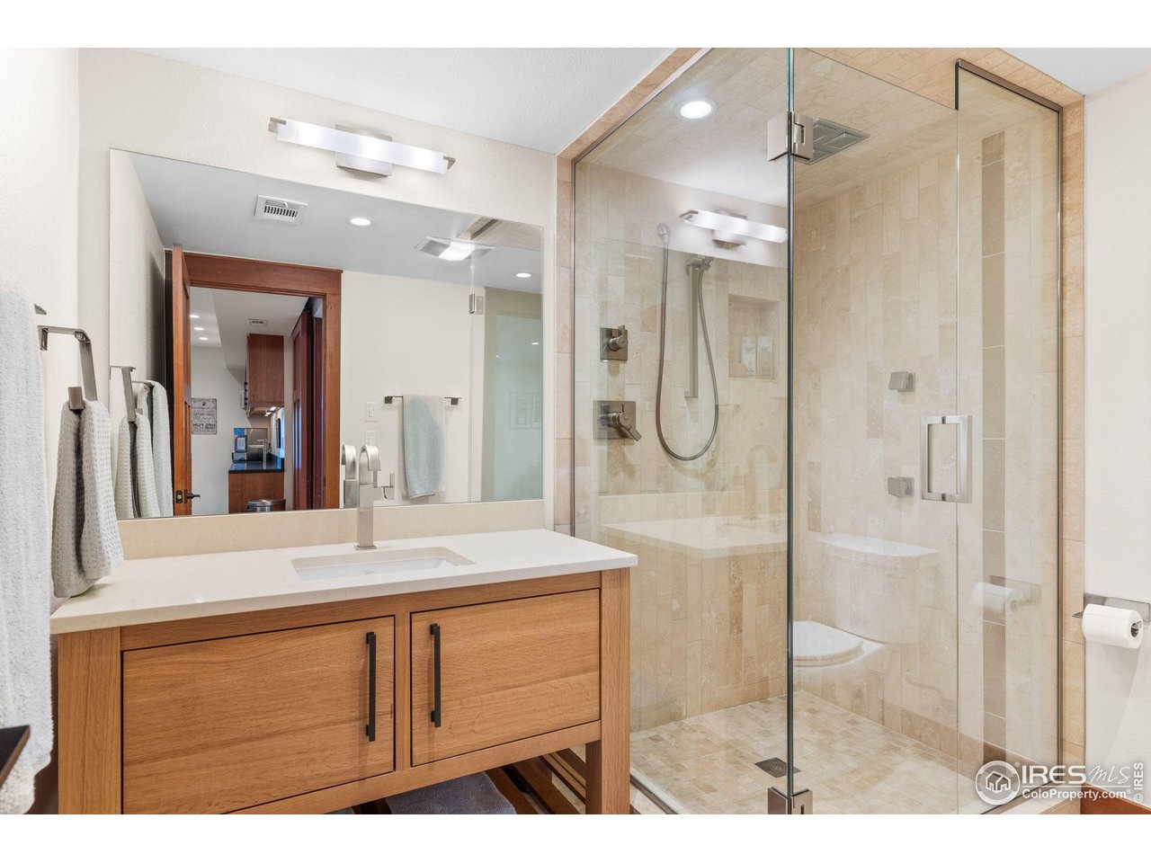 2545 Tamarack Avenue Boulder, CO 80304 - Photo 35 of 40 a bathroom with a shower sink and mirror
