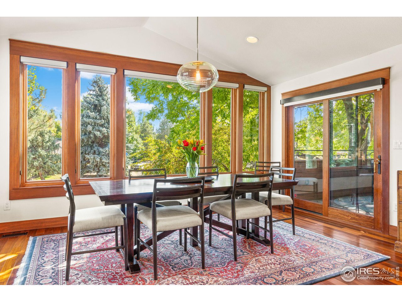 2545 Tamarack Avenue Boulder, CO 80304 - Photo 9 of 40 a dining room with furniture large windows and wooden floor