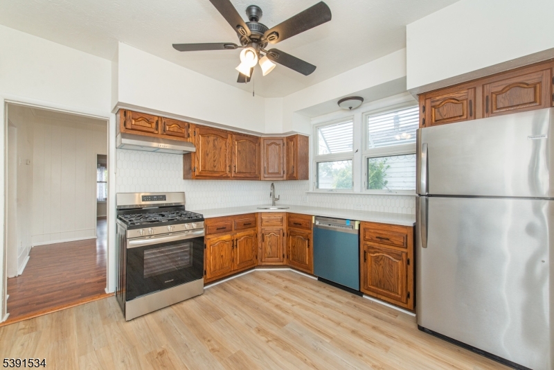638 Clifton Avenue Clifton, NJ 07011 - Photo 11 of 21 a kitchen with stainless steel appliances granite countertop a refrigerator a stove a sink and a microwave