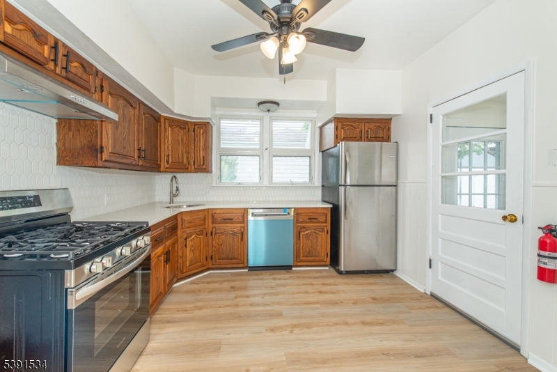638 Clifton Avenue Clifton, NJ 07011 - Photo 12 of 21 a kitchen with stainless steel appliances granite countertop a stove cabinets and refrigerator