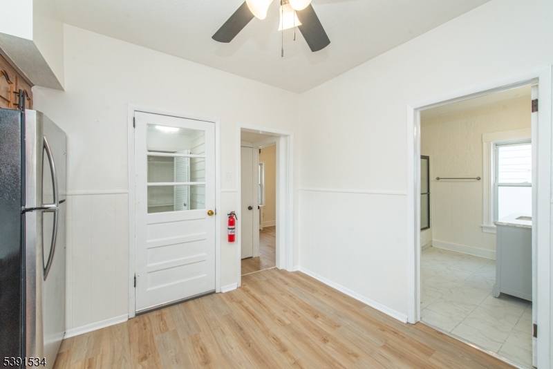 638 Clifton Avenue Clifton, NJ 07011 - Photo 13 of 21 a view of empty room with wooden floor and fan
