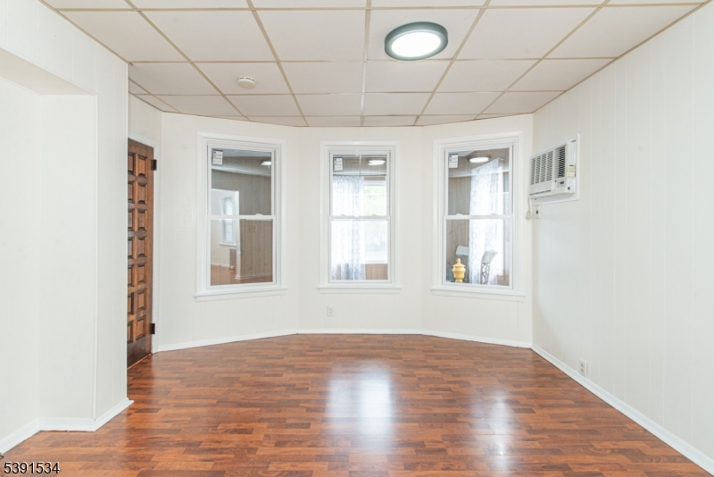 638 Clifton Avenue Clifton, NJ 07011 - Photo 9 of 21 a view of an empty room with wooden floor and a window