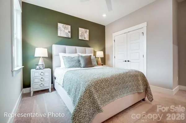 a bedroom with a bed and a night stand