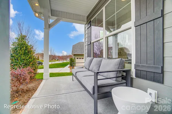 a view of a porch with furniture and a yard