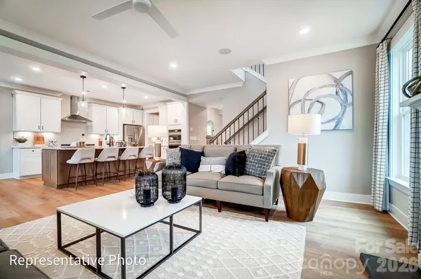a living room with lots of furniture and kitchen view