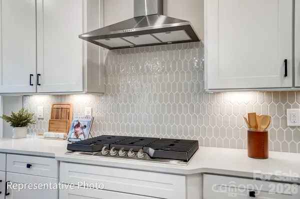 a kitchen with granite countertop cabinets and white appliances