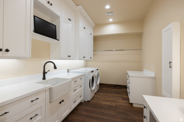 6117 North Rocky Ridge Road Peoa, UT 84061 - Photo 70 of 82 Laundry room featuring extensive white cabinetry, a farmhouse sink with a gooseneck faucet, light-colored countertops, and wood-finish flooring