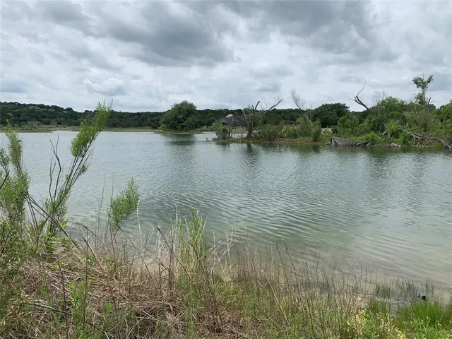a view of a lake with houses in the back