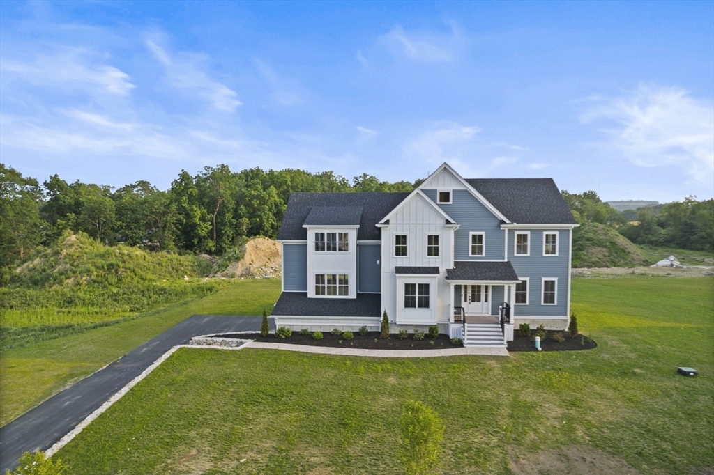 Lot 7 Weeping Willow Drive Andover, MA 01810 - Photo 1 of 42 a front view of a house with a yard table and chairs