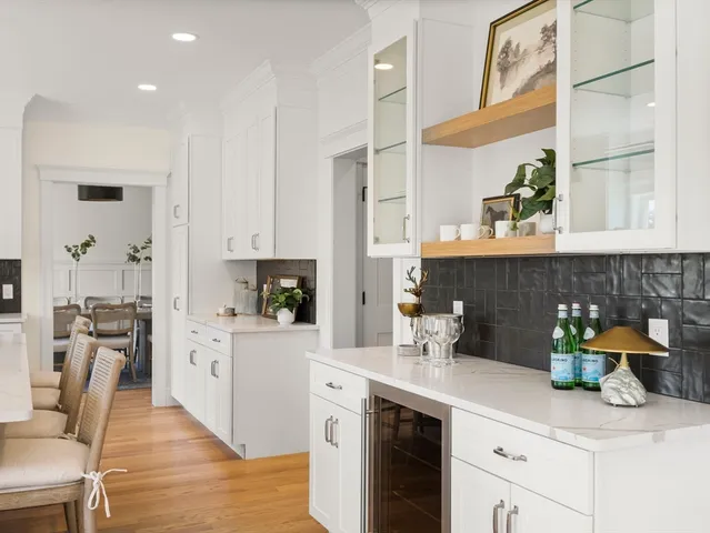a kitchen with stainless steel appliances kitchen island granite countertop a table and chairs in it