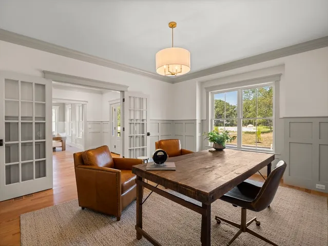 a view of a dining room with furniture window and wooden floor