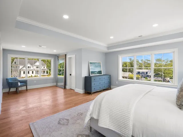 a spacious bedroom with a large bed and a large window