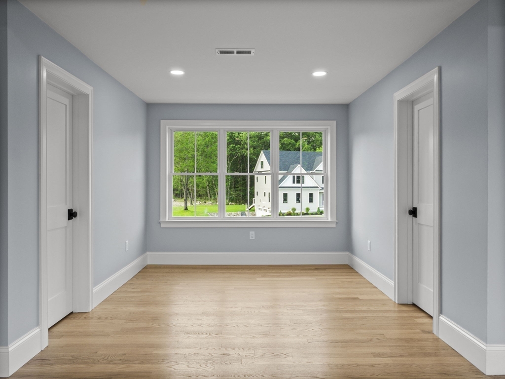 Lot 7 Weeping Willow Drive Andover, MA 01810 - Photo 20 of 42 a view of an empty room with wooden floor and a window
