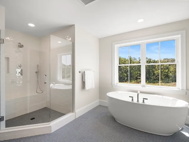 a bathroom with a bathtub and shower