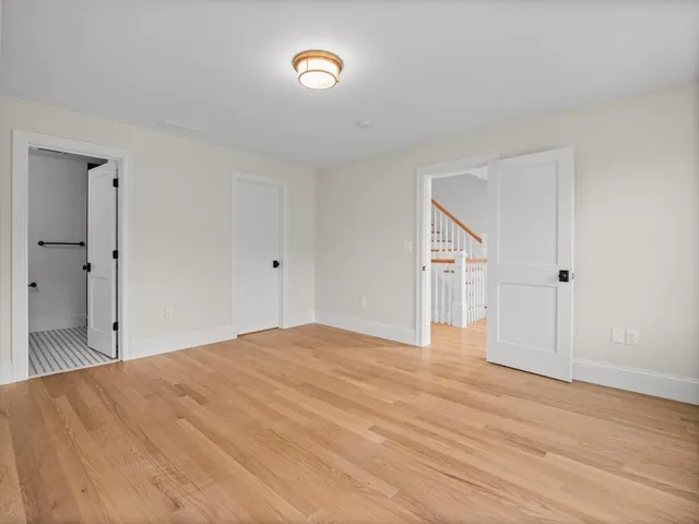 a big room with wooden floor and natural light