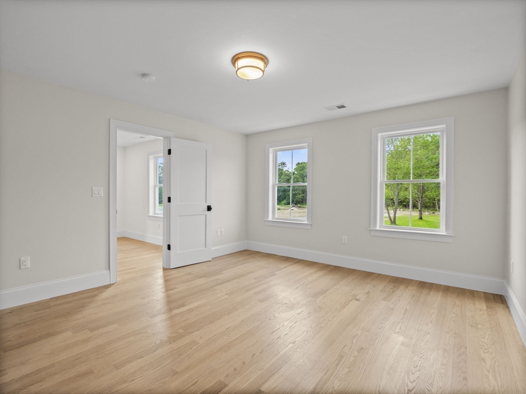 Lot 7 Weeping Willow Drive Andover, MA 01810 - Photo 24 of 42 an empty room with wooden floor and windows