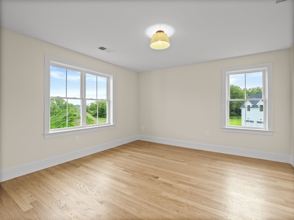 Lot 7 Weeping Willow Drive Andover, MA 01810 - Photo 26 of 42 an empty room with wooden floor and windows
