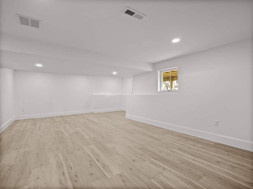 Lot 7 Weeping Willow Drive Andover, MA 01810 - Photo 32 of 42 a view of an empty room with a window and wooden floor