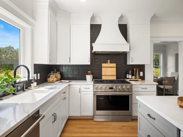 a kitchen with a stove top oven and sink
