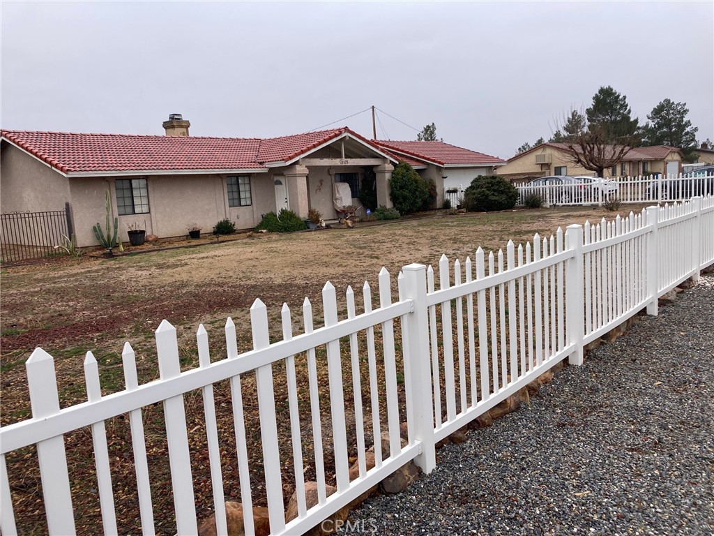 15575 Apache Road Apple Valley, CA 92307 - Photo 1 of 1 a front view of a house with wooden fence
