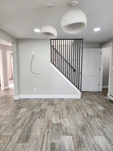a view of a room with wooden floor and windows