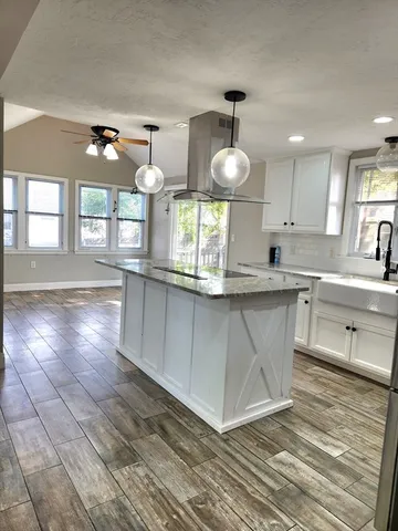 a kitchen with stainless steel appliances granite countertop a sink a stove counter space and cabinets