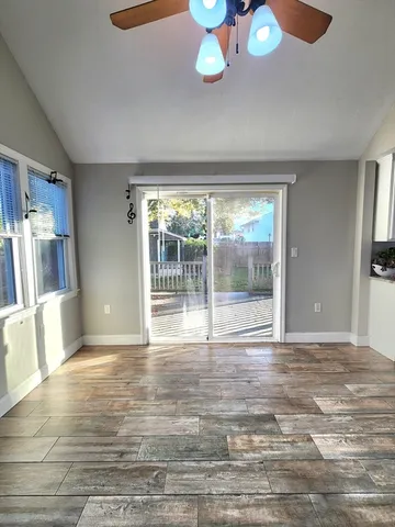 a view of empty room with wooden floor