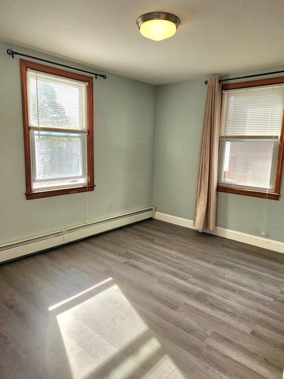 42 Ancona Road Worcester, MA 01604 - Photo 22 of 42 an empty room with wooden floor and windows