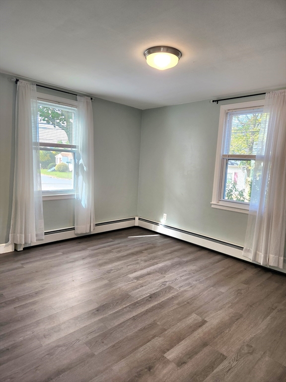 42 Ancona Road Worcester, MA 01604 - Photo 23 of 42 an empty room with wooden floor and windows
