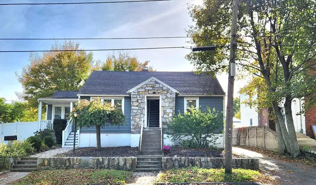 a front view of a house with garden