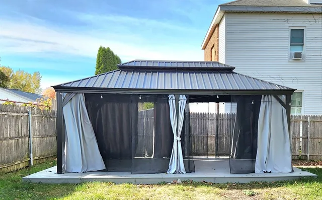 a view of a house with backyard and deck