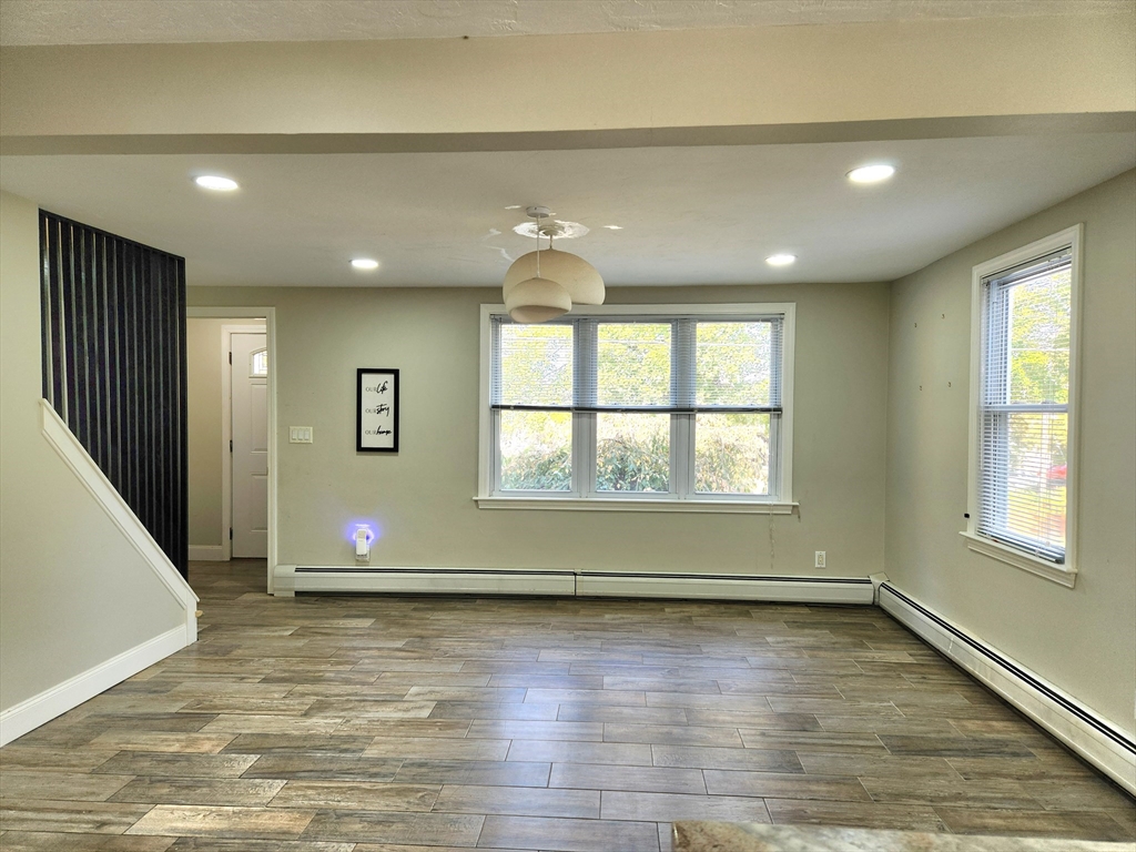 42 Ancona Road Worcester, MA 01604 - Photo 8 of 42 an empty room with wooden floor and windows
