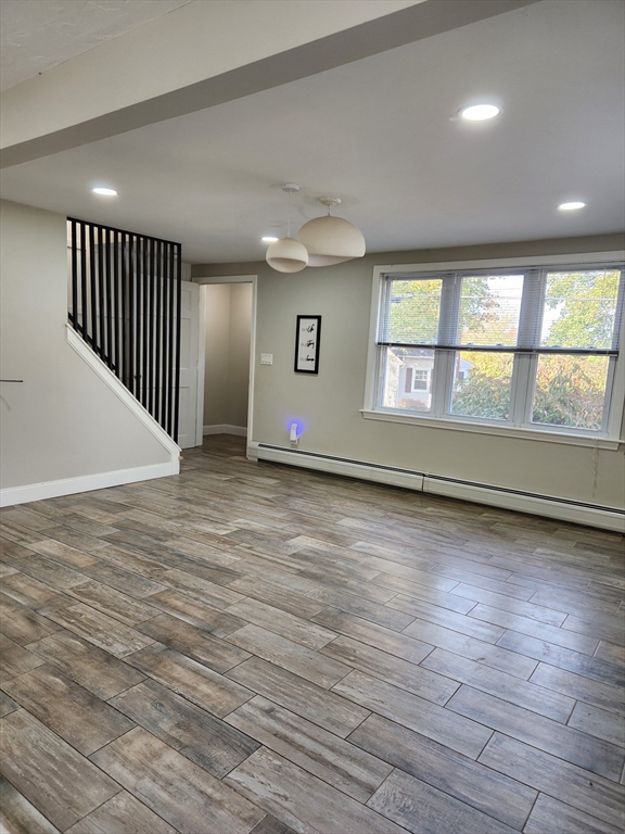 42 Ancona Road Worcester, MA 01604 - Photo 9 of 42 an empty room with wooden floor and windows