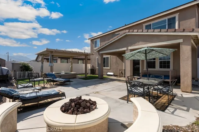 a view of a patio with table and chairs and potted plants