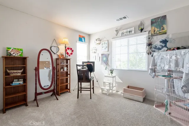 a view of living room filled with furniture and a window