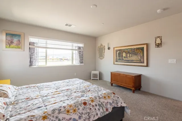 a bedroom with bed and window