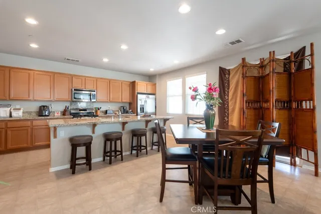 a view of kitchen with cabinets table and chairs
